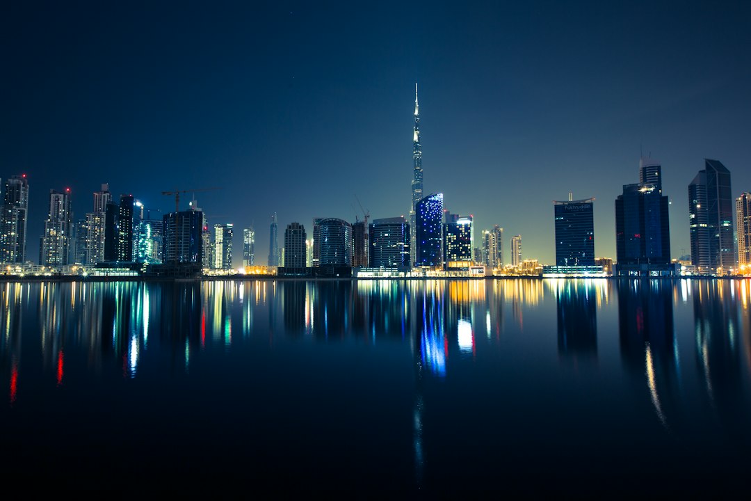Dubai Business Bay skyline at night, reflected in the water