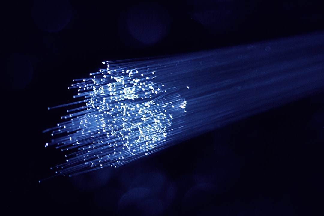 Fibre optic strands lit against a dark background