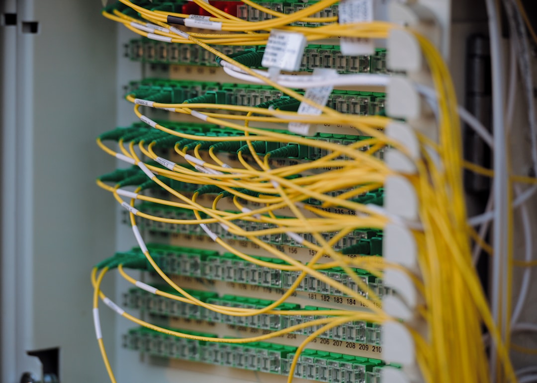 Yellow and green fibre patch cables in a network cabinet
