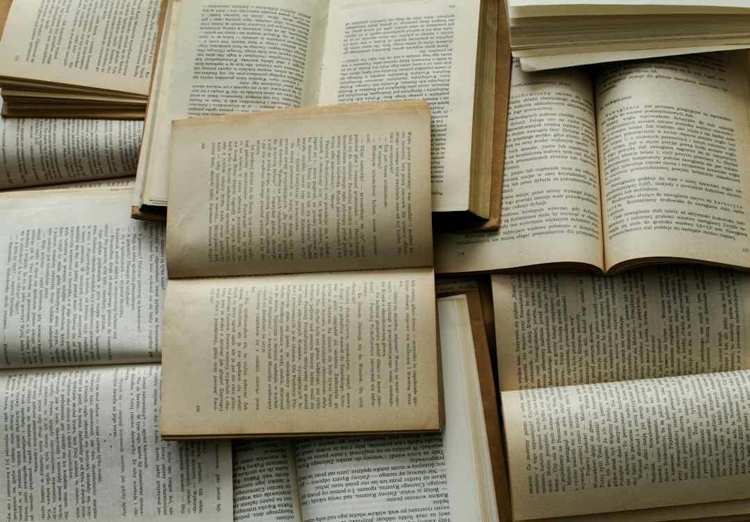 Open books laid out on a table, pages facing up