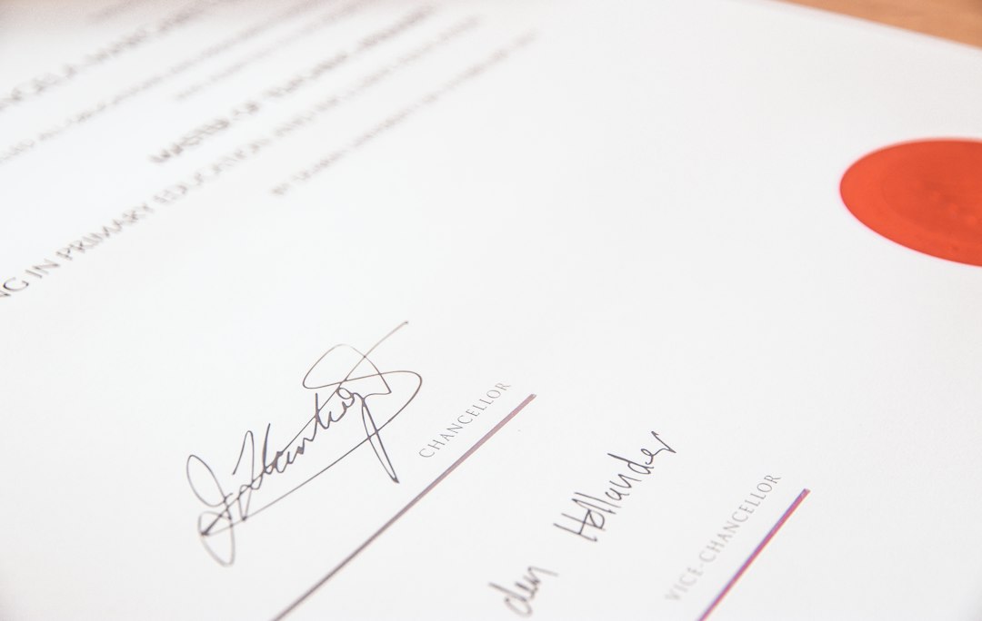 A certificate with a red seal and two signatures