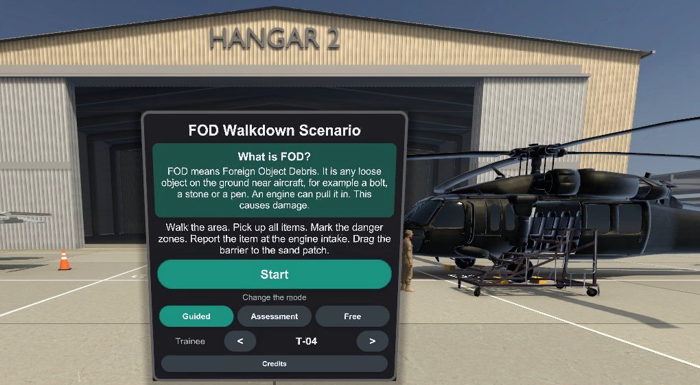 The briefing board in the FOD walkdown demo, standing in front of a hangar and a helicopter on the apron: what FOD is, the trainee's tasks, a Start button, a choice of guided, assessment or free mode, and the trainee code